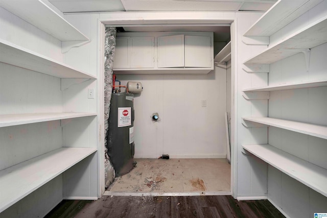 laundry area featuring water heater, cabinets, and hookup for an electric dryer