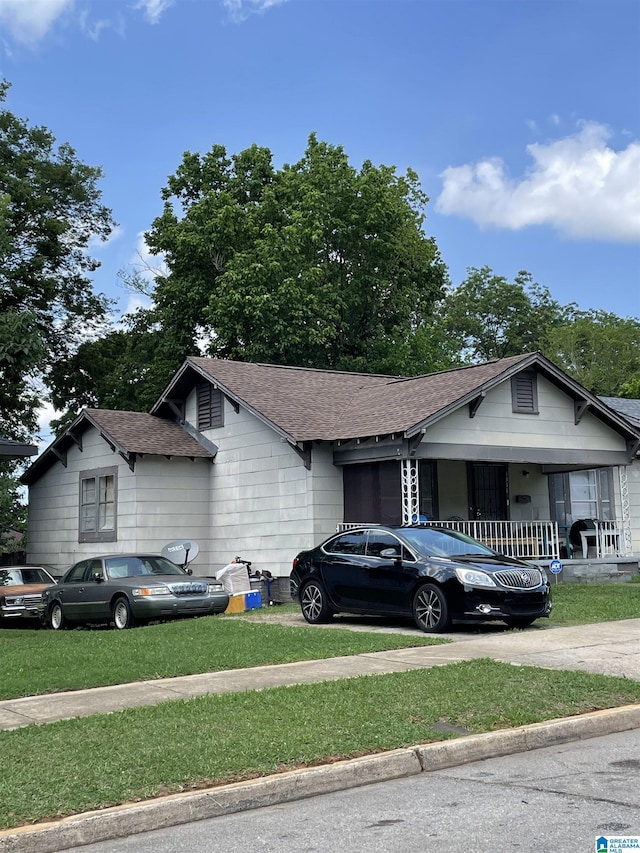 view of front of house with a front lawn and covered porch