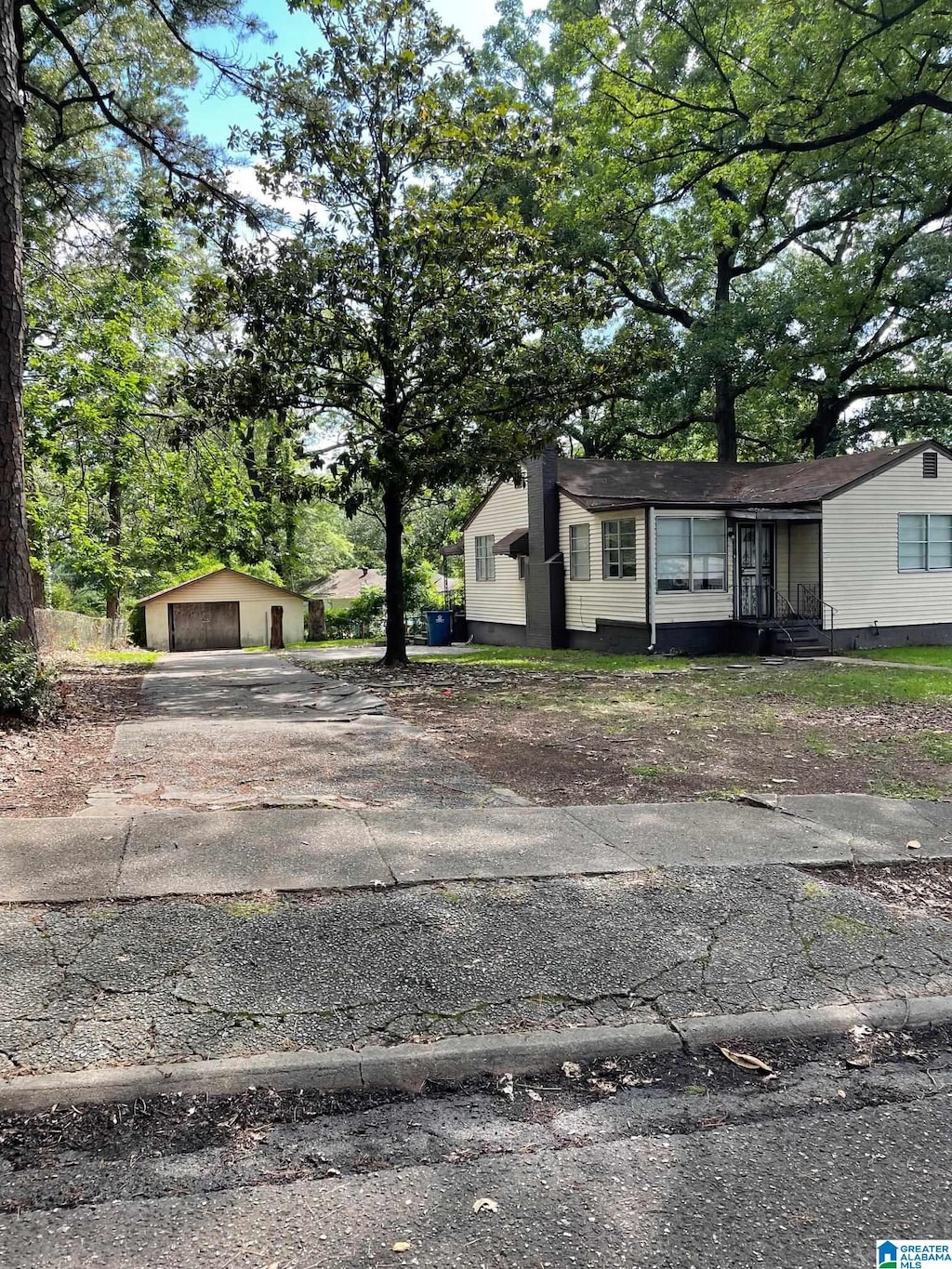 view of front facade featuring an outbuilding and a garage