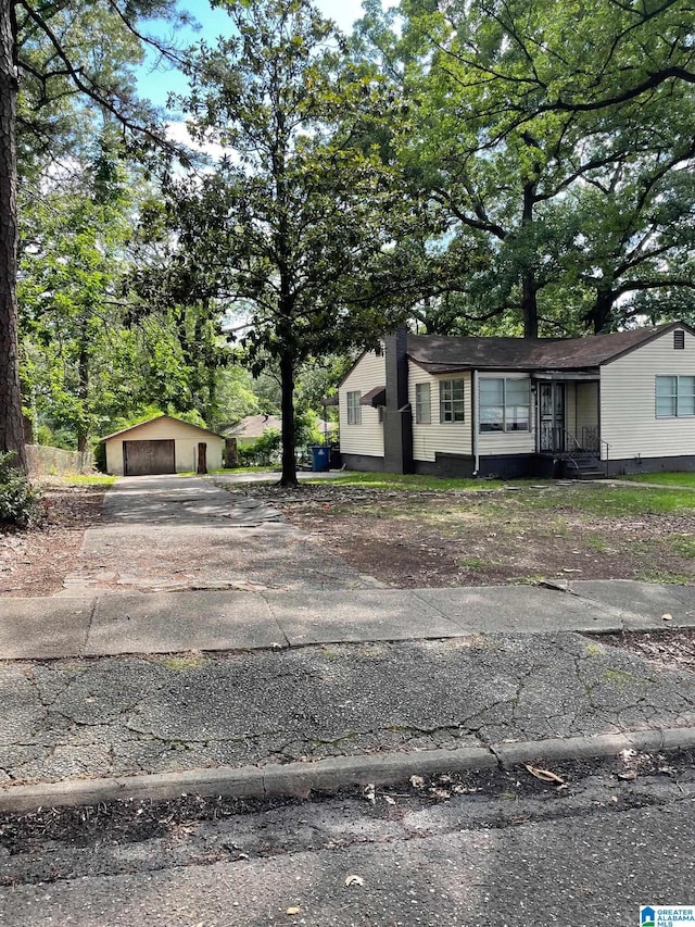 view of front facade featuring an outbuilding and a garage