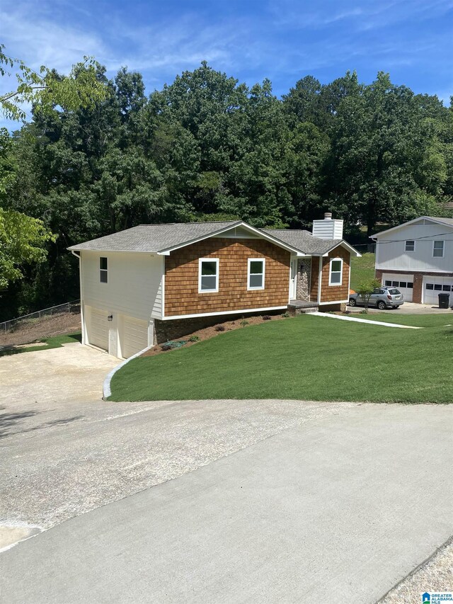 view of front of house with a garage and a front yard