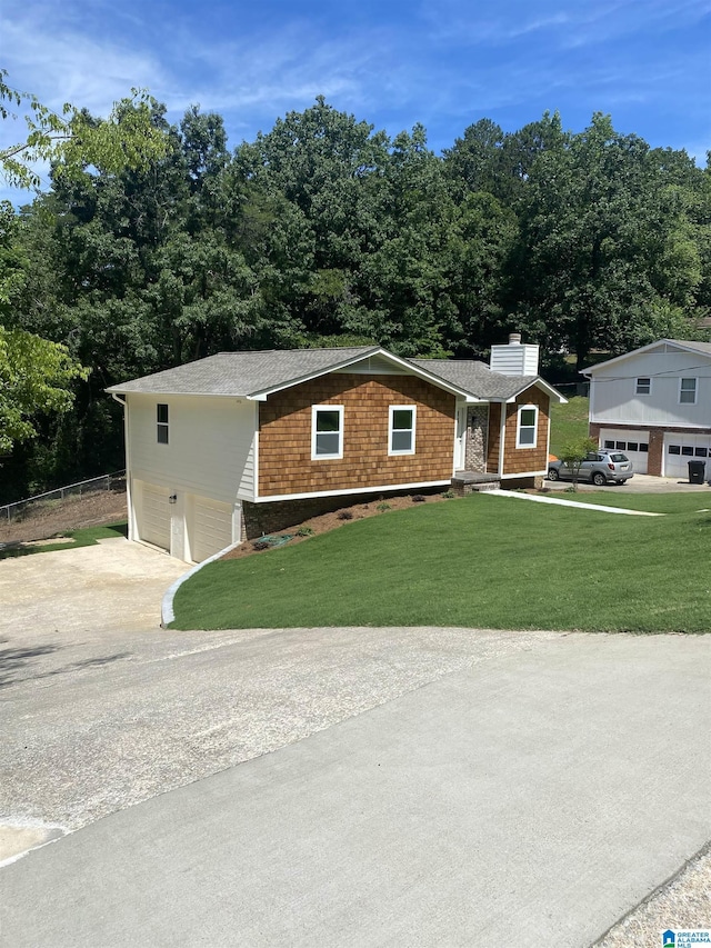 view of front of home with a garage and a front lawn