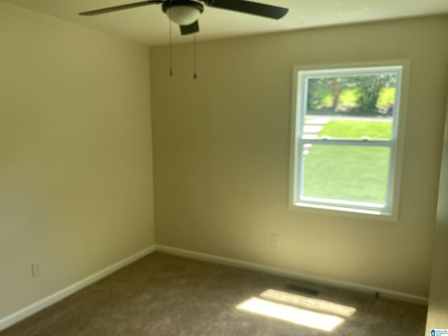 spare room featuring ceiling fan and carpet