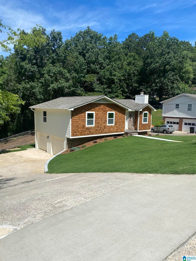 view of front of house with a front lawn and a garage