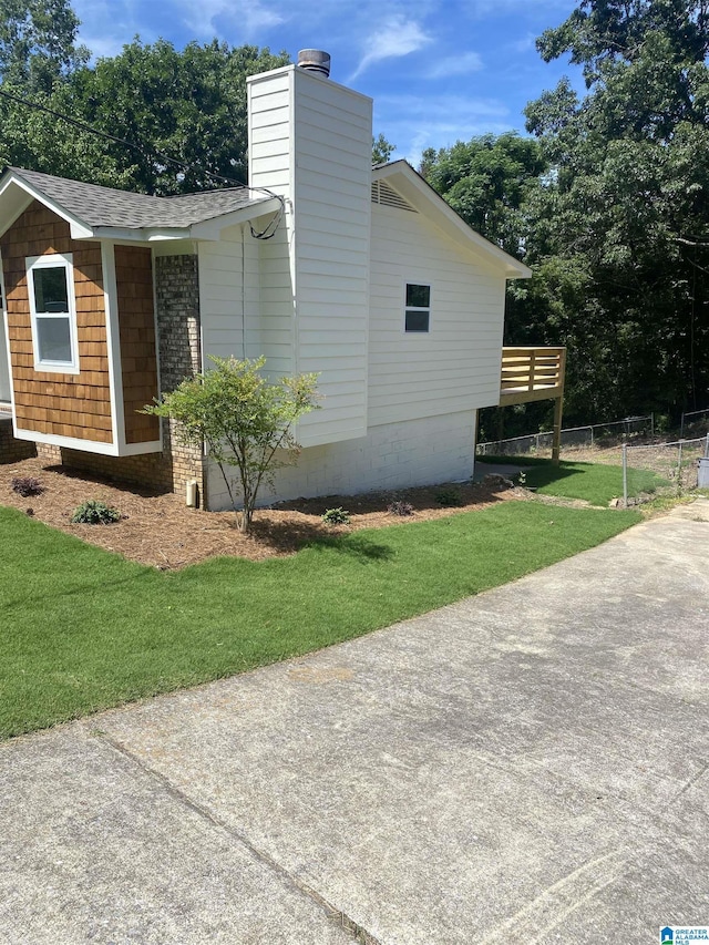 view of home's exterior with a lawn