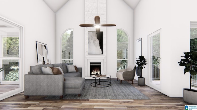 living room with high vaulted ceiling, wood-type flooring, a large fireplace, and ceiling fan