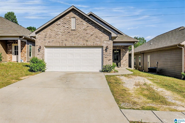 view of front of property featuring cooling unit and a garage