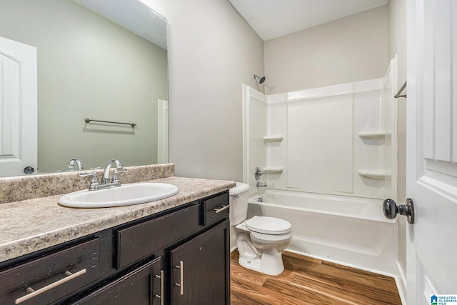 full bathroom featuring vanity, toilet, wood-type flooring, and bathtub / shower combination