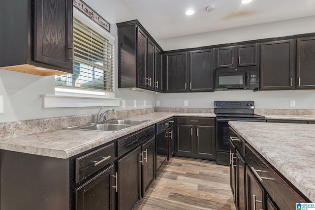 kitchen featuring sink, black appliances, dark brown cabinets, and light hardwood / wood-style floors