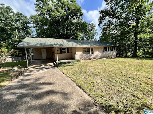 ranch-style home featuring a front yard and a carport