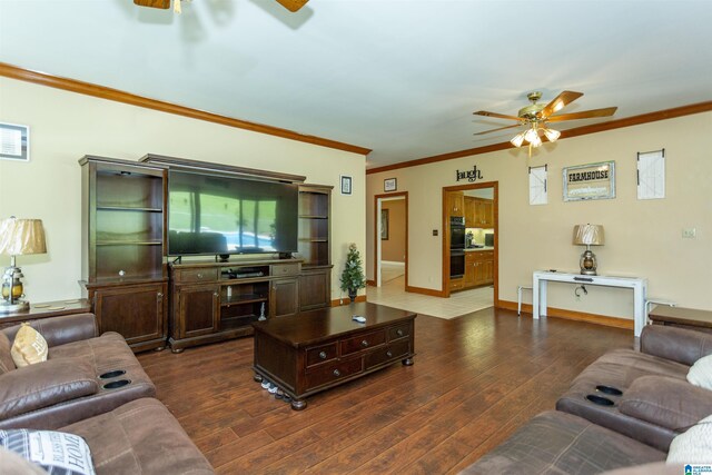 living room featuring dark hardwood / wood-style floors, ceiling fan, and ornamental molding