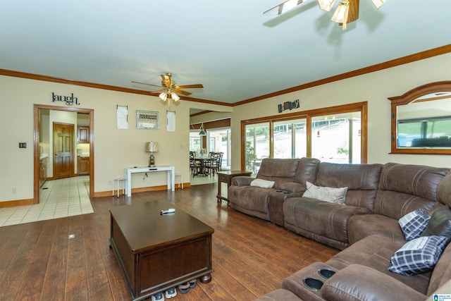 living room with dark hardwood / wood-style floors, ceiling fan, and crown molding