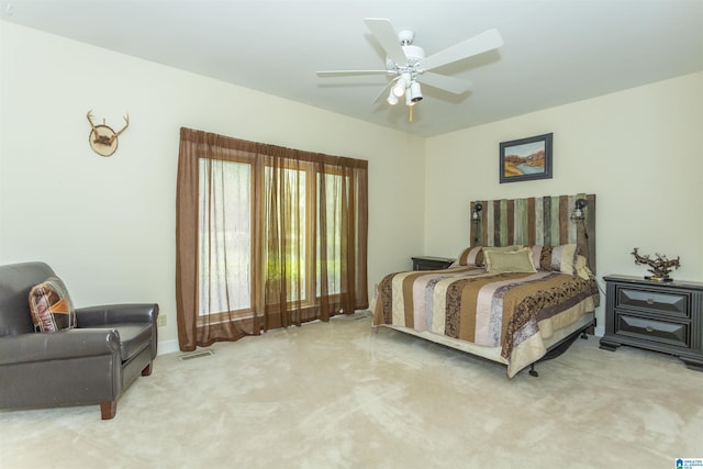 bedroom with ceiling fan and light colored carpet