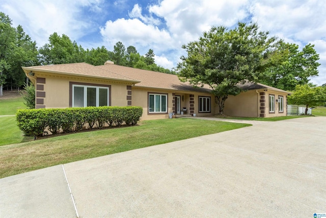 ranch-style house with a front lawn