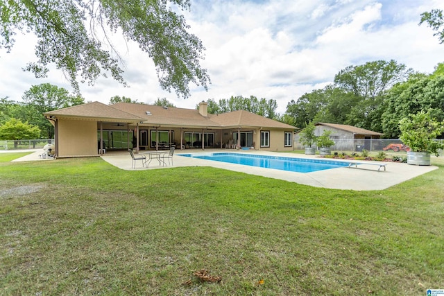 view of pool featuring a patio area and a yard