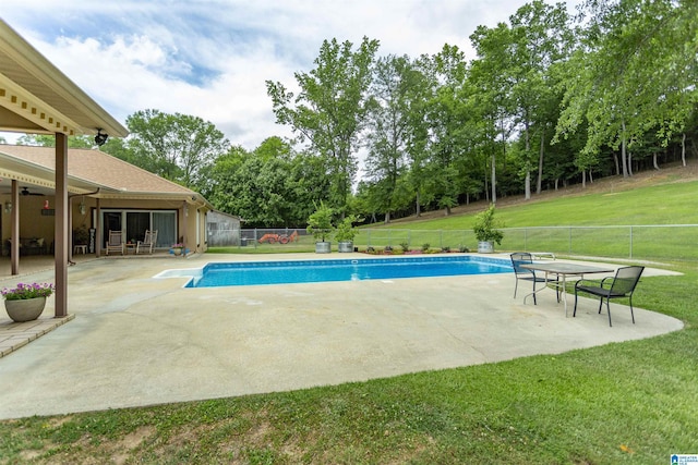 view of swimming pool featuring a lawn and a patio area