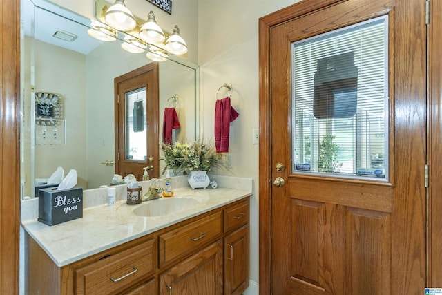 bathroom with vanity and an inviting chandelier