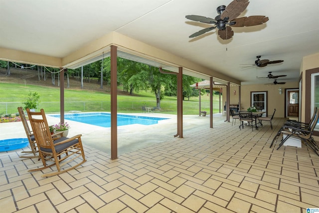 view of swimming pool featuring a patio and ceiling fan