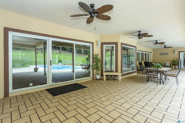 sunroom / solarium with ceiling fan