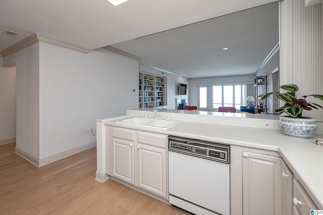 kitchen with visible vents, ornamental molding, a sink, light wood-style floors, and dishwasher