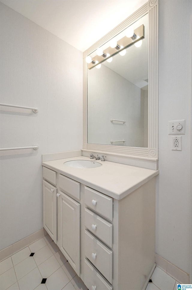 bathroom featuring tile patterned floors, vanity, and baseboards