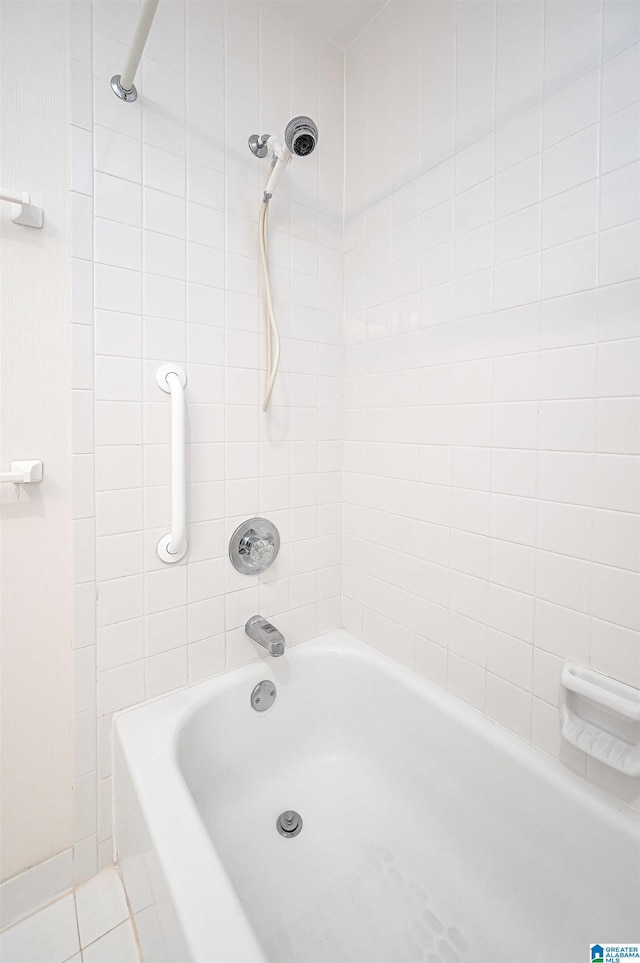 bathroom with tile patterned floors and shower / tub combination