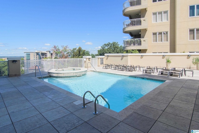 view of swimming pool with a patio and a pool with connected hot tub