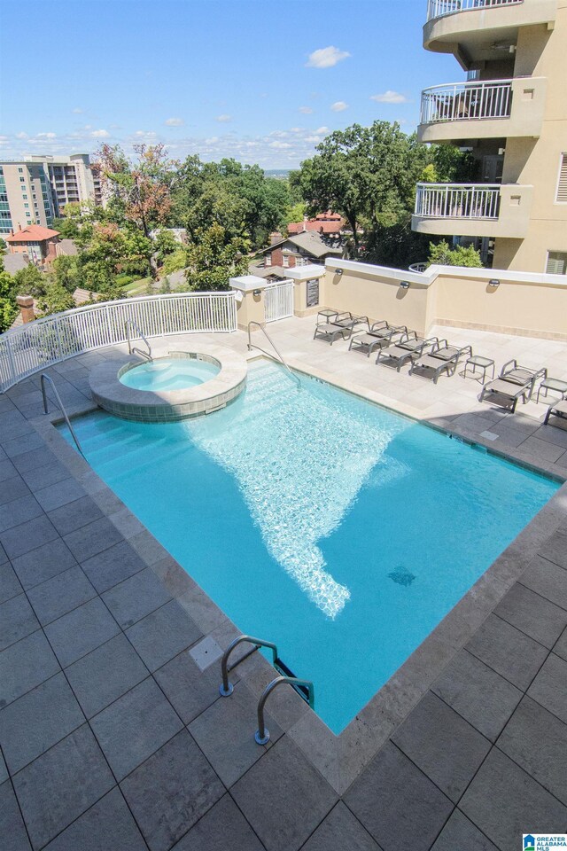 view of pool featuring a patio and a pool with connected hot tub
