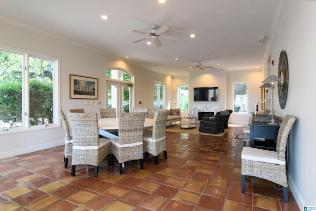 dining room featuring dark tile patterned flooring, a ceiling fan, recessed lighting, crown molding, and baseboards