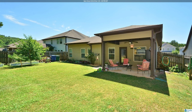 rear view of house featuring a patio, a yard, and ceiling fan