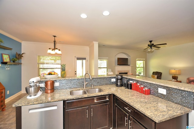 kitchen with sink, crown molding, dark brown cabinetry, decorative light fixtures, and stainless steel dishwasher