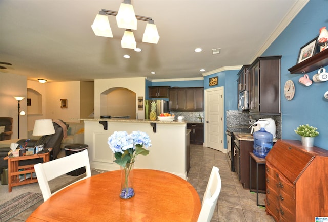 tiled dining area featuring ornamental molding