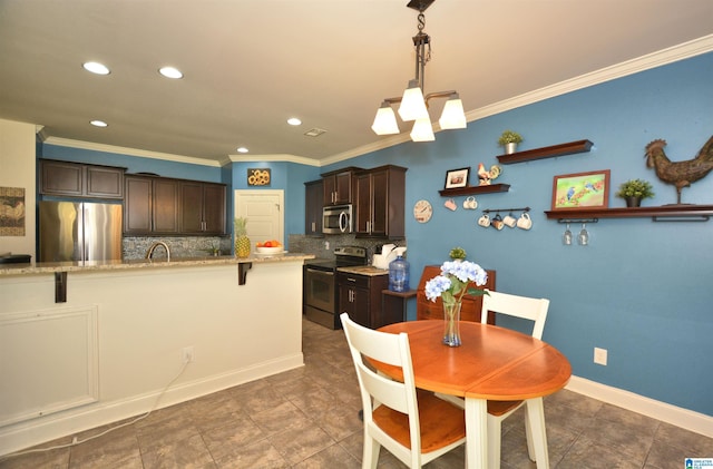 dining room featuring an inviting chandelier, sink, and crown molding