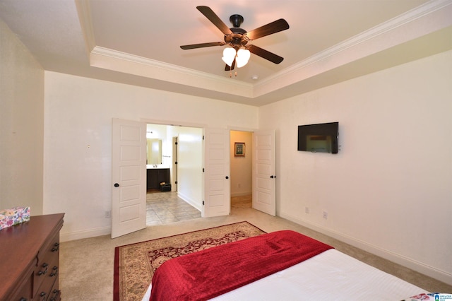 carpeted bedroom with crown molding, ceiling fan, connected bathroom, and a raised ceiling