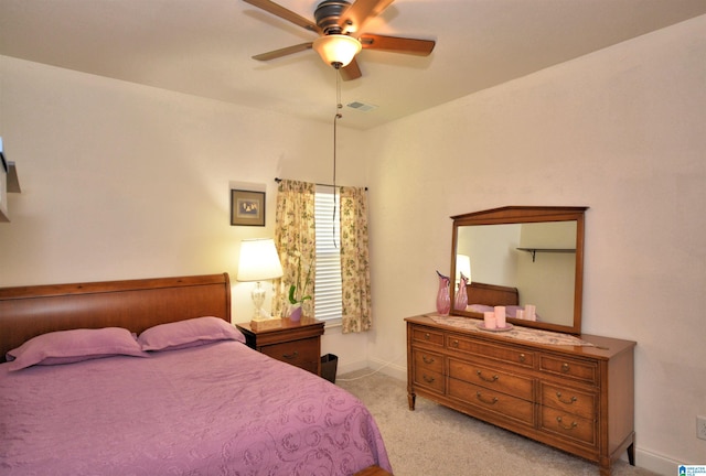 bedroom with ceiling fan and light carpet