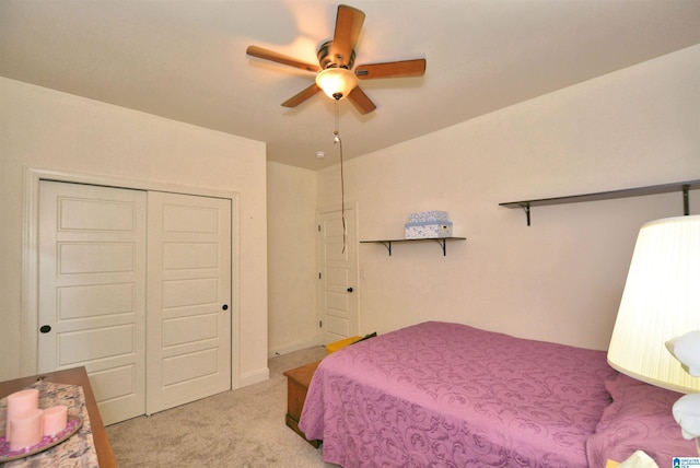 carpeted bedroom with ceiling fan and a closet