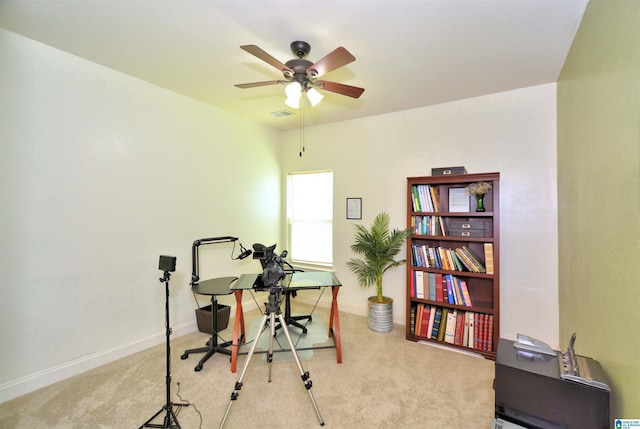 office space featuring ceiling fan and light colored carpet