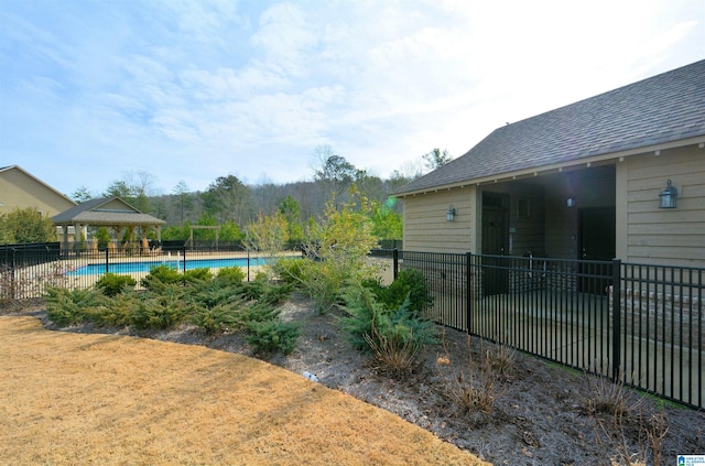 view of yard featuring a fenced in pool and a gazebo