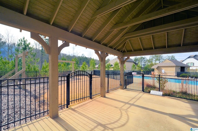 view of patio with a community pool and a gazebo