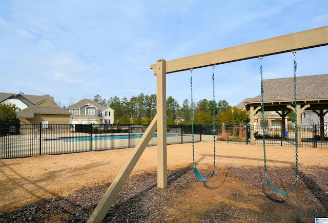 view of jungle gym with a community pool