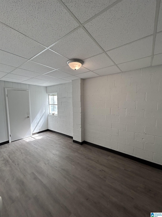 1616 Hatchet Ave, Tarrant, AL 35217 - unfurnished room with dark wood-type flooring, concrete block wall, and a drop ceiling