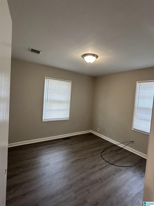 kitchen featuring white cabinets, dark wood-type flooring, and sink