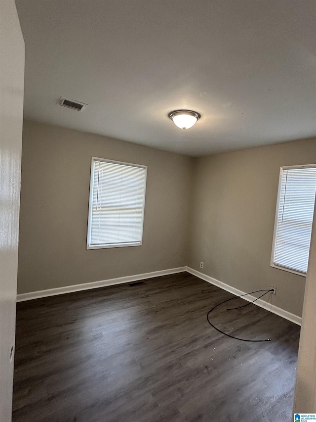 1616 Hatchet Ave, Tarrant, AL 35217 - unfurnished room with a wealth of natural light, visible vents, baseboards, and dark wood-style floors