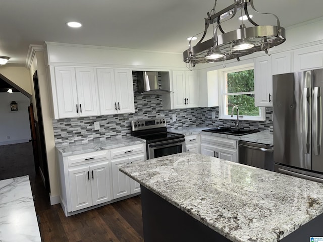 kitchen with white cabinetry, sink, a center island, wall chimney range hood, and appliances with stainless steel finishes