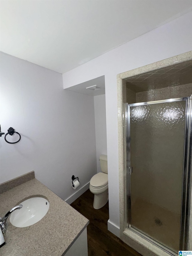 bathroom with vanity, a shower with shower door, and toilet