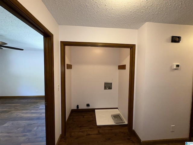 hall featuring dark wood-type flooring and a textured ceiling