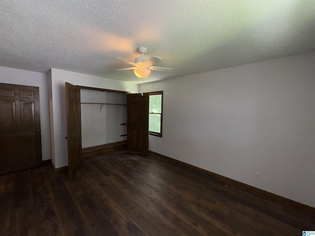 unfurnished bedroom featuring a closet, ceiling fan, dark hardwood / wood-style flooring, and a textured ceiling