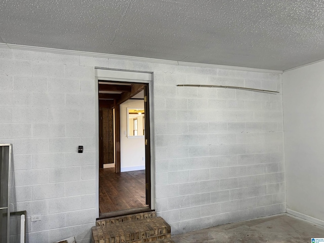 unfurnished room with concrete flooring and a textured ceiling