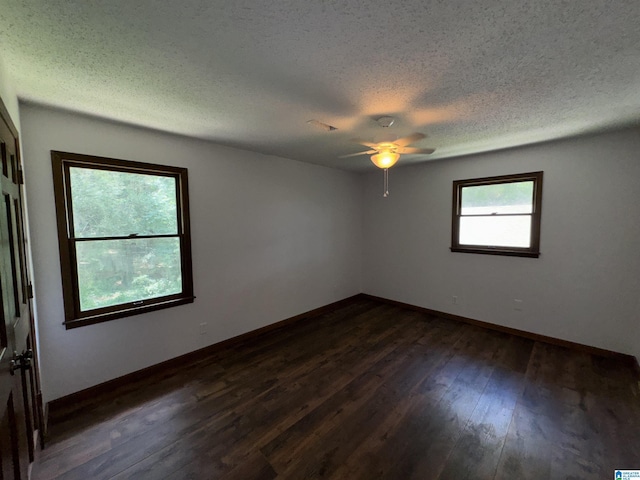 unfurnished room with a textured ceiling, ceiling fan, and dark wood-type flooring