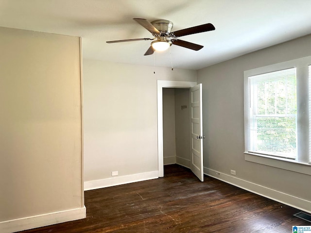 unfurnished bedroom featuring ceiling fan and dark wood-type flooring